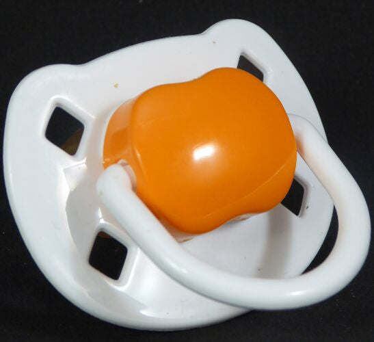 White & orange Spanish style dummy with Nuk teat
