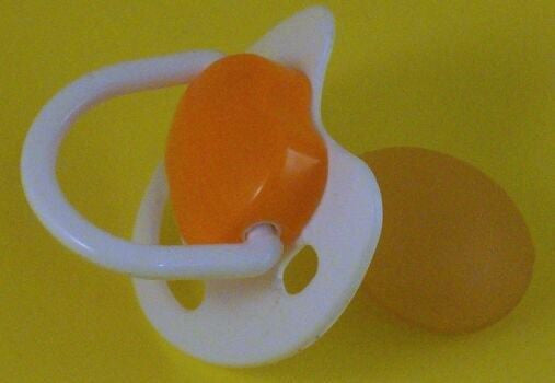 White and orange Spanish style dummy with Nuk teat